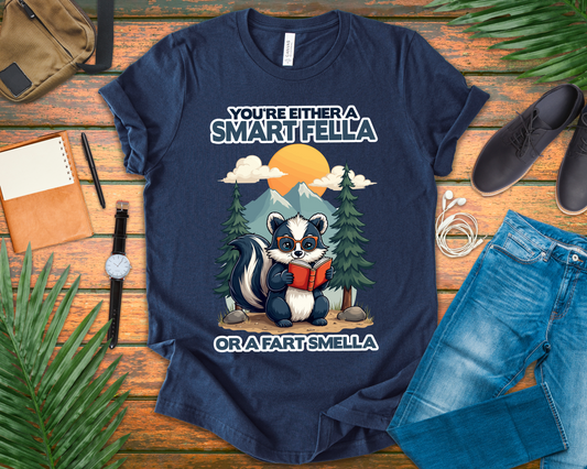 You're Either a Smart Fella or a Fart Smella Tshirt – Skunk in Colorful Space Suit with Sun & Mountain Background