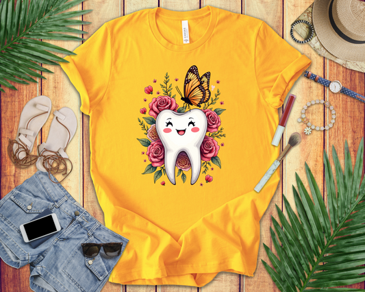 Smile T Shirt Featuring Large Smiling Tooth Surrounded by Flowers Leaves and Butterflies