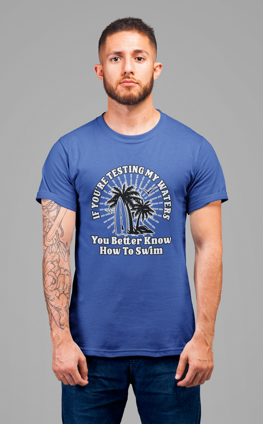 Test My Waters Surf T-Shirt – Beach Palm Trees & Rocks Graphic with Bold Quote